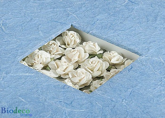 Detail van de biologisch afbreekbare urn Bloemen Boeket, ingelegd met witte papieren roosjes, voor een asbijzetting in de aarde